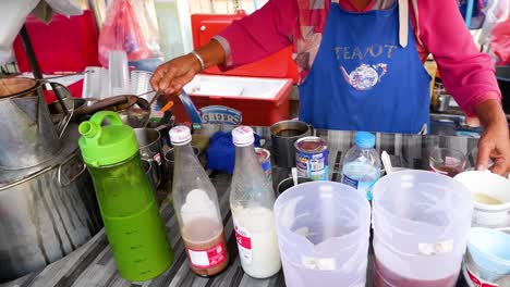 preparing traditional thai tea at a street stall