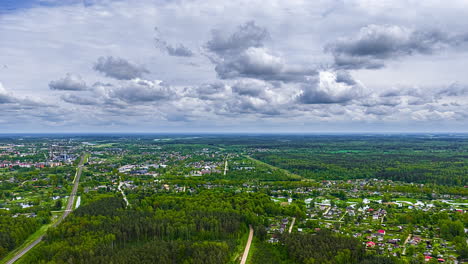 cumulus clouds forming and flowing above countryside towns in rural europe - high altitude aerial time lapse