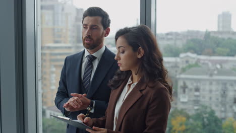 entrepreneur explaining woman assistant work responsibilities in office close up