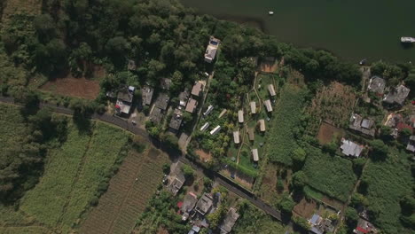 Aerial-top-view-of-countryside-district-agricultural-fields-streets-roofs-of-houses-forest