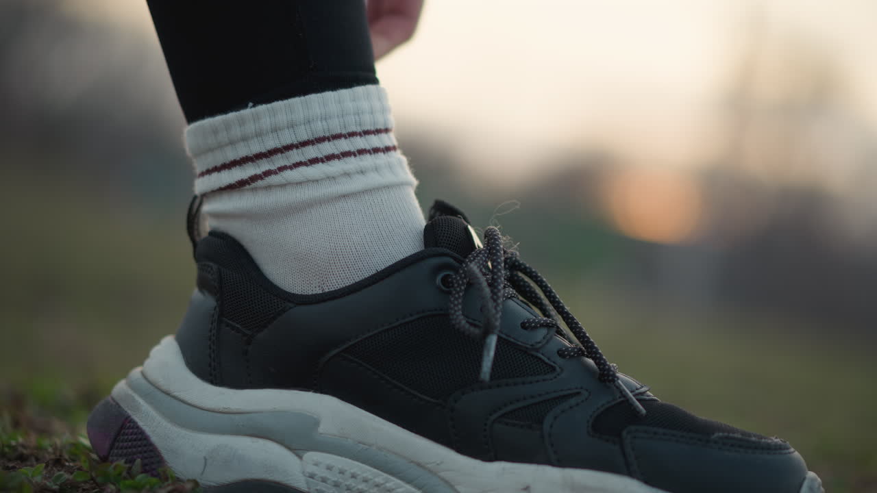 Sock Adjustment Process, Person Carefully Adjusting Sock And Shoe, Moving Sock Over Shoe With Careful Hand Placement, Person Skillfully Positions Sock Over Sneaker With Delicate Handling