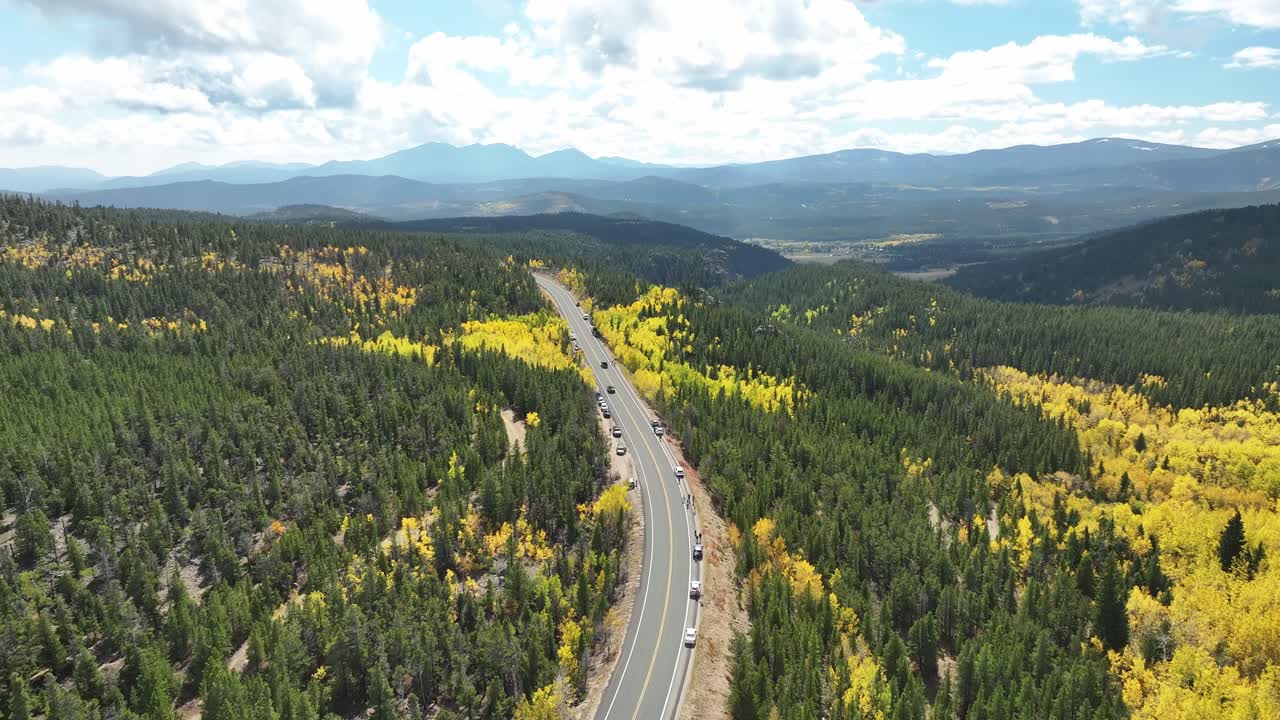 Tourists gather along the sides of this mountain road to capture pictures of the beautiful fall aspen trees