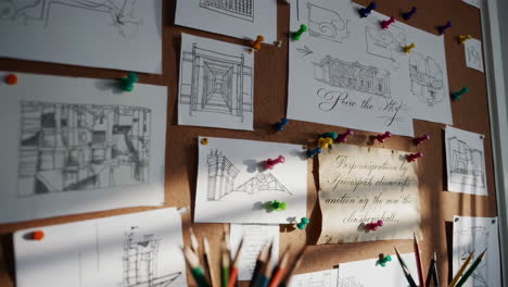 corkboard with architectural drawings and notes