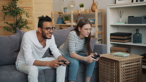 couple playing video games at home