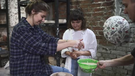 women learning pottery in a workshop