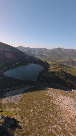 mágico lago de montaña de ausente en las montañas de españa, vista vertical de fpv aérea