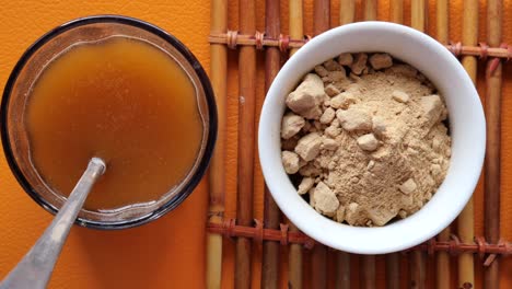 mixing brewers yeast flakes in a glass of water