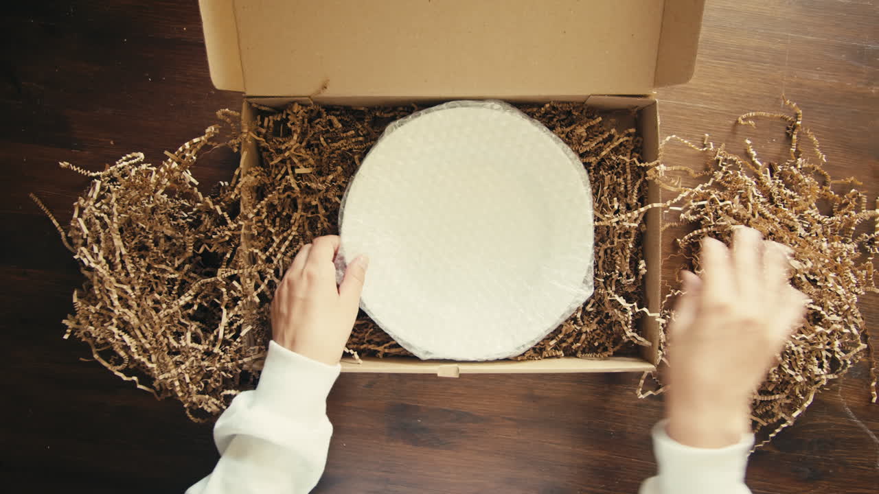 E-commerce storage shop, woman packing goods and clothes for second hand delivery market, dedicated Packaging and Shipping Workspace with Supplies and Technology for efficiency, online sales.