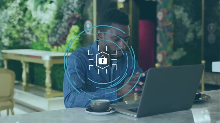 Animation of padlock with circles over african american businessman using smartphone by laptop