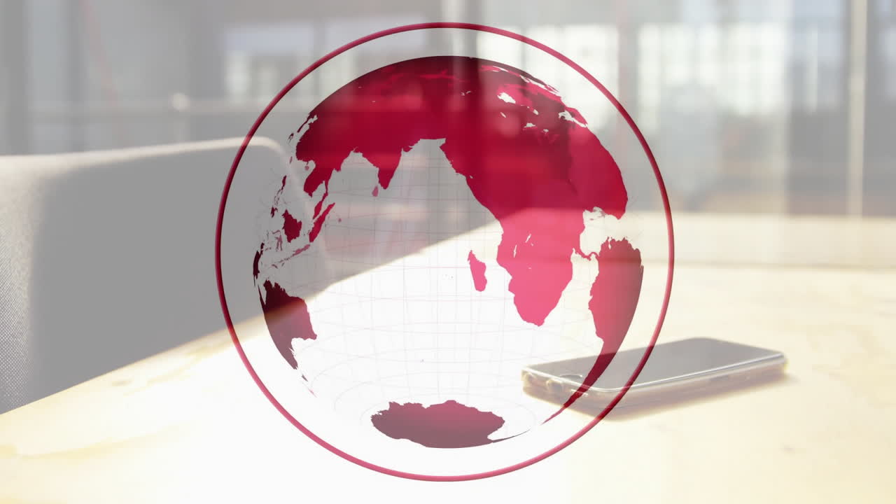 Red globe graphic displaying over wooden desk, featuring smartphone and blurred office background