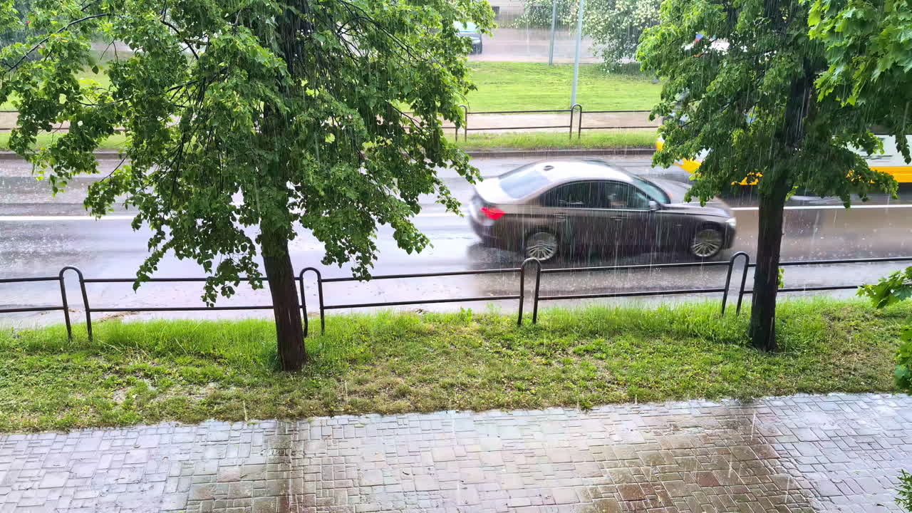 Traffic Through Asphalt Road During Rainy Day. High Angle Shot