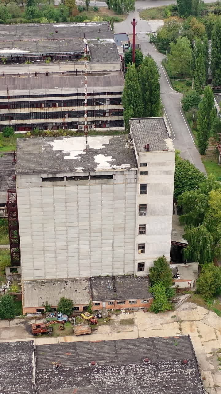 Exterior of industrial destroyed buildings. Destroyed aerial view of huge territory factory. Vertical video