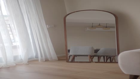 arched mirror with wooden frame in a modern living room