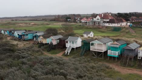 slider drone shot of colourful beach huts english seaside