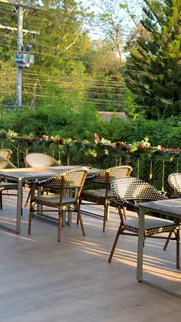 quiet restaurant patio with empty tables and chairs