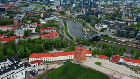 gediminas castle tower with new arsenal, palace of the grand dukes, neris river and vilnius old town in lithuania