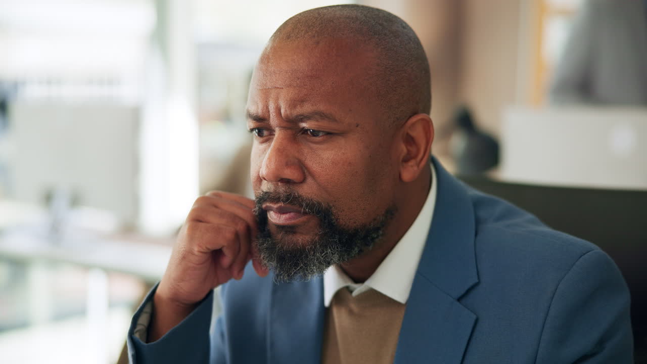 Thoughtful Businessman Concentrating and Thinking in a Modern Office