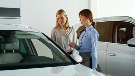 woman discussing car purchase with sales associate