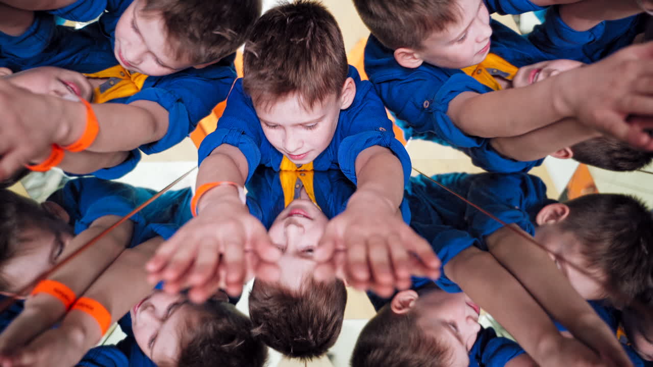 Child in a kaleidoscope tunnel. Mirror reflection of a child. Baby's emotions