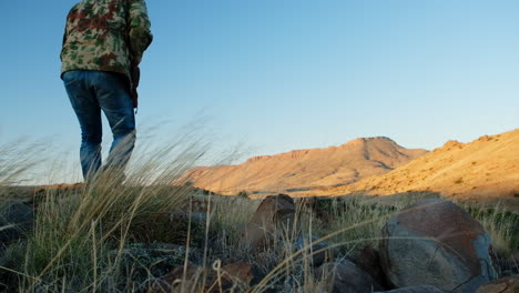 hunter slowly walks up with hunting rifle takes aim and shoots, karoo landscape