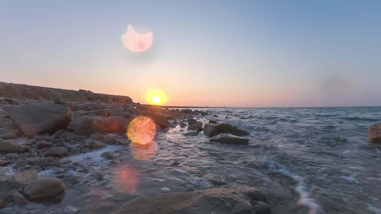 Timelapse of ocean waves hitting rocks during marvelous sunset sea