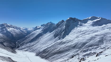Vast Snowy Mountain Valley with Frozen River