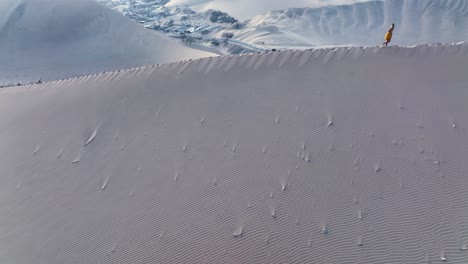 woman walking by sand dune