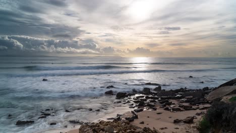 Sandy-beach-and-pabbles-during-sunset-on-Estepona-coastline,-time-lapse