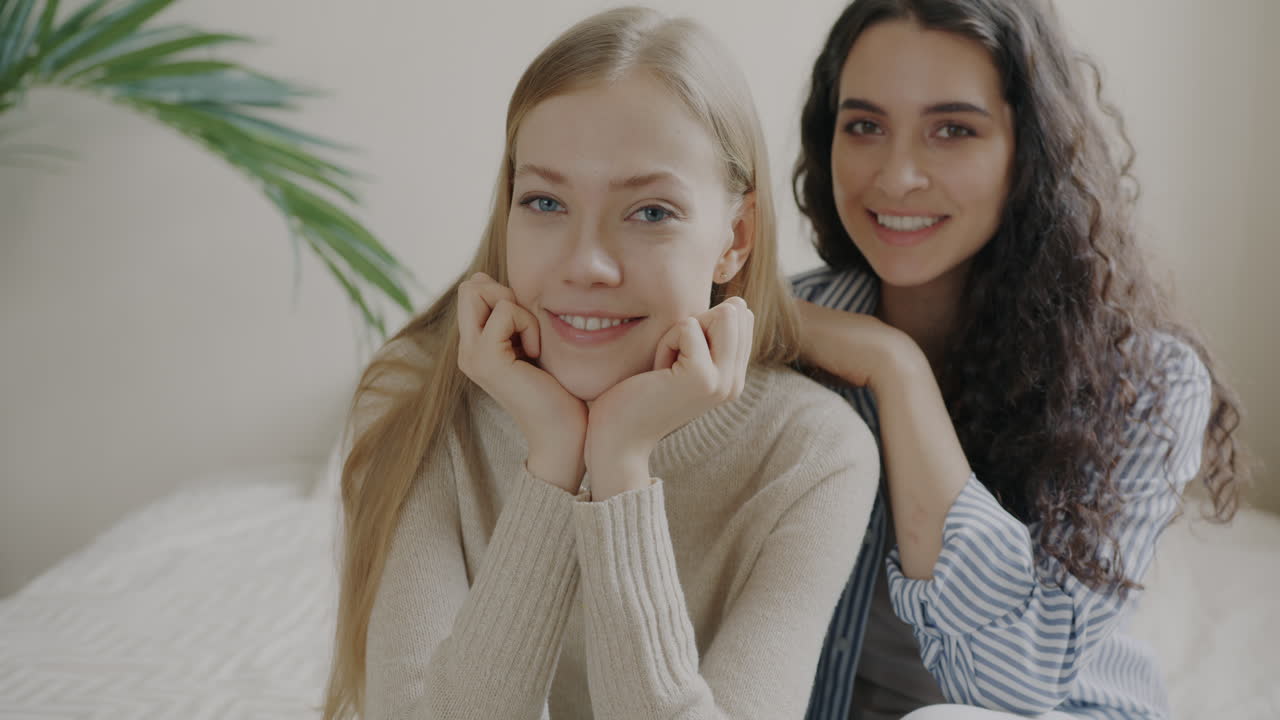Two happy young women smiling at the camera