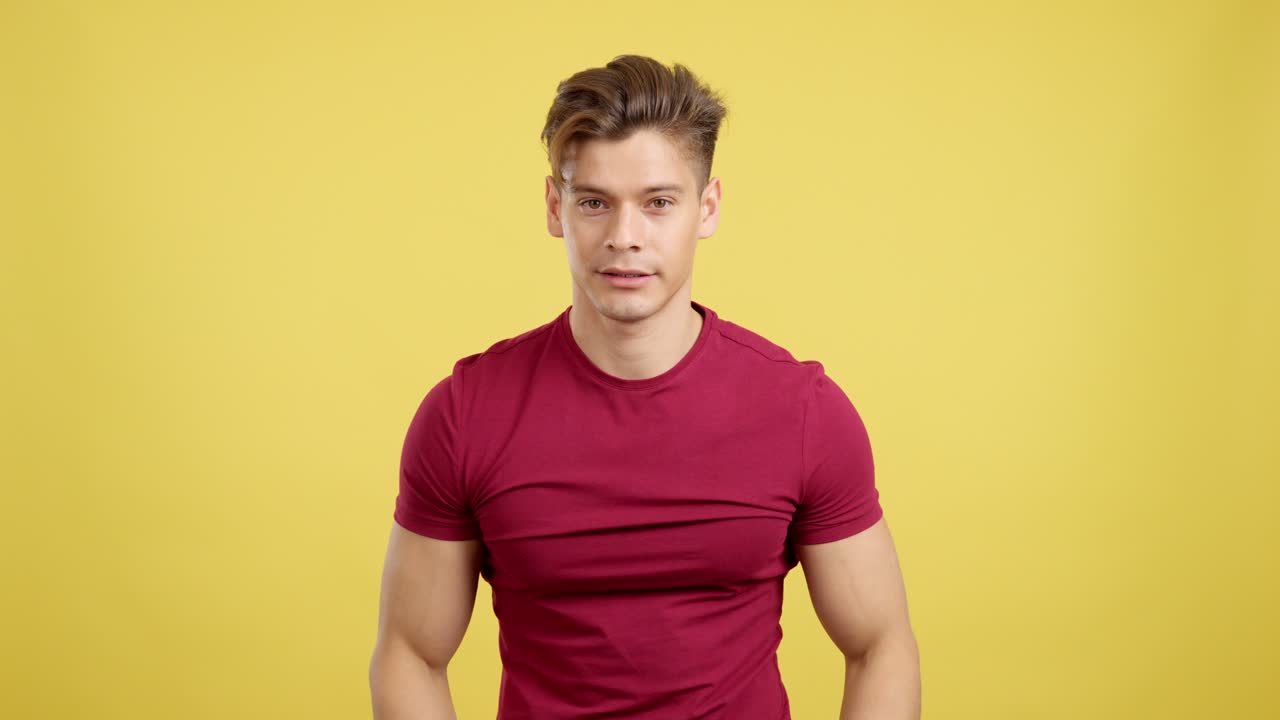 Man showing shocked and surprised reactions against a yellow background