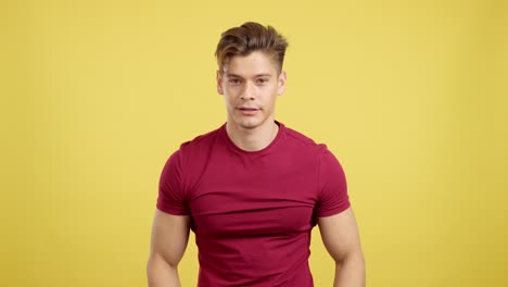 man showing shocked and surprised reactions against a yellow background