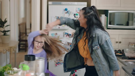 happy-sisters-dancing-together-in-kitchen-having-fun-celebrating-weekend-at-home-enjoying-dance-celebration