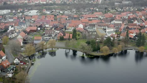 drone aerial view of the traditional german village herzberg am harz in the famous national park in central germany on a cloudy day in winter.