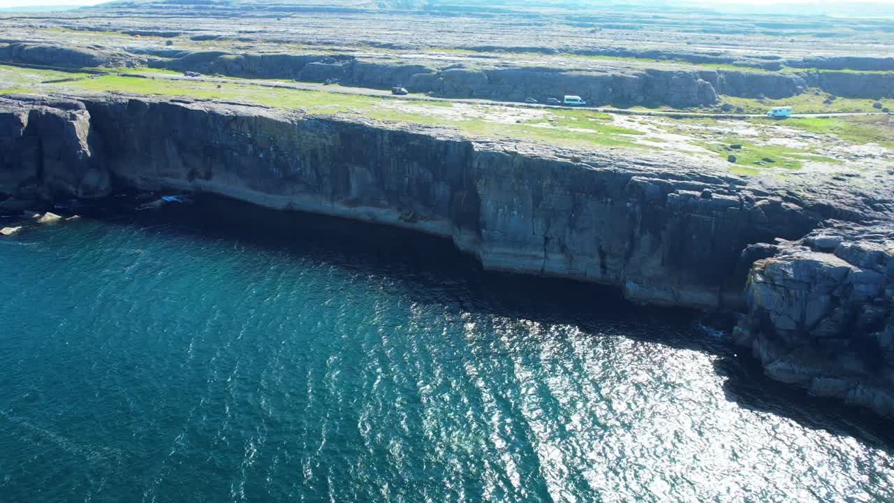 Camper vans drive along the coast road through the Burren Wild Atlantic way Ireland
