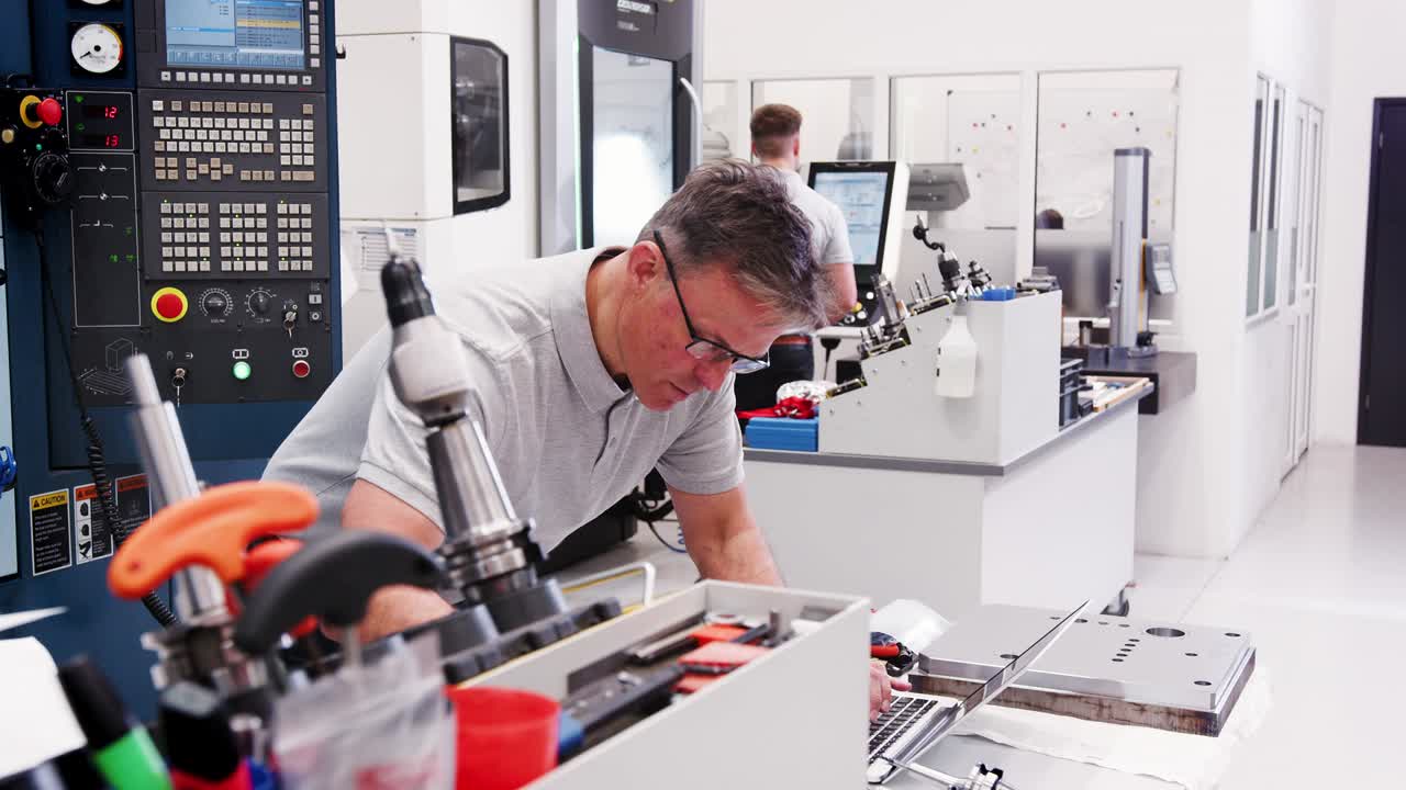 Mature Male Engineer Using CAD Programming Software On Laptop