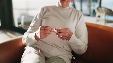 senior woman knitting at home