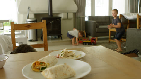 Father-cleaning-floor-while-kids-playing-4k