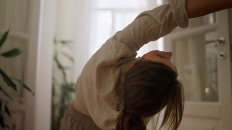 woman practicing a yoga pose at home