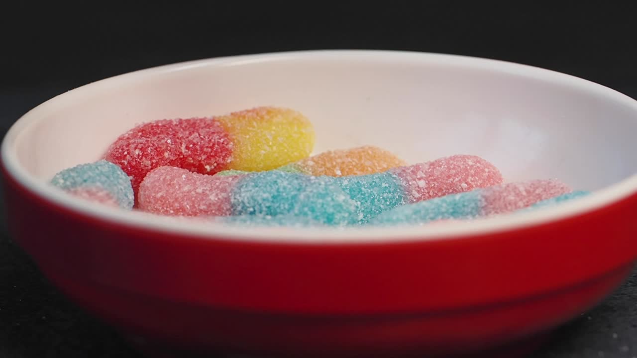Colorful Gummy Worms in a Red Bowl