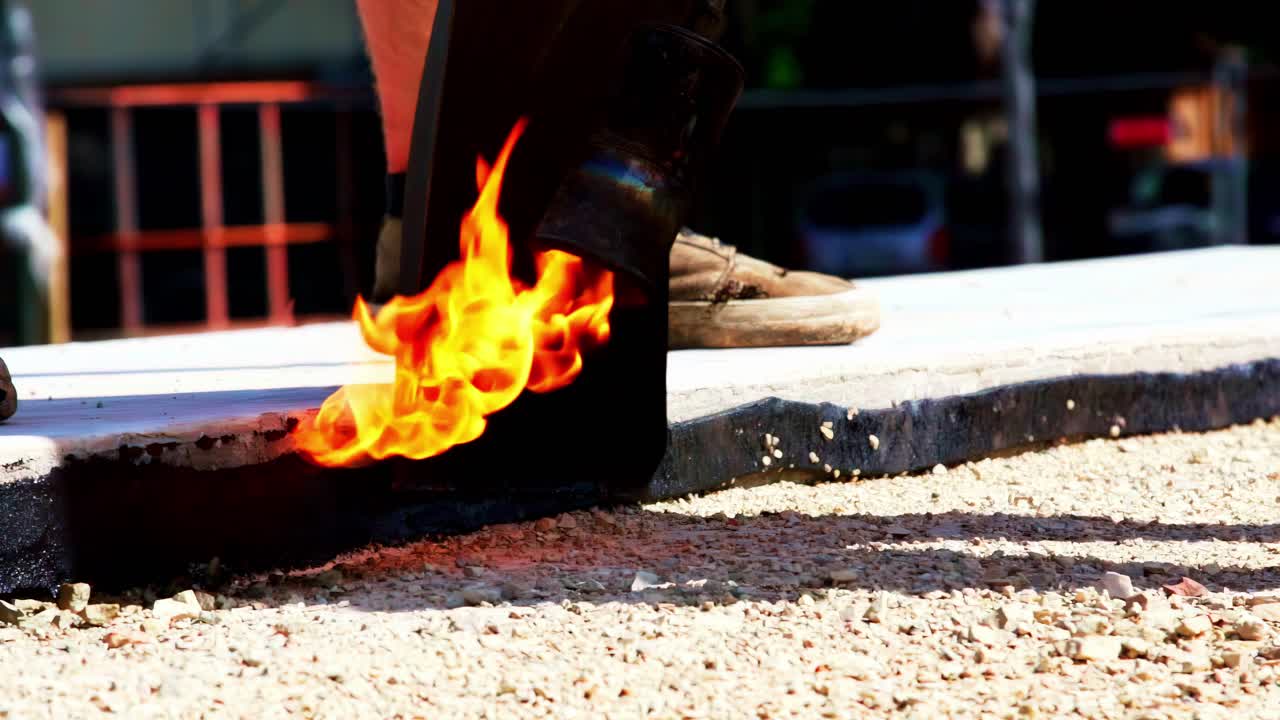 Close-up of torch with flame applied to surface