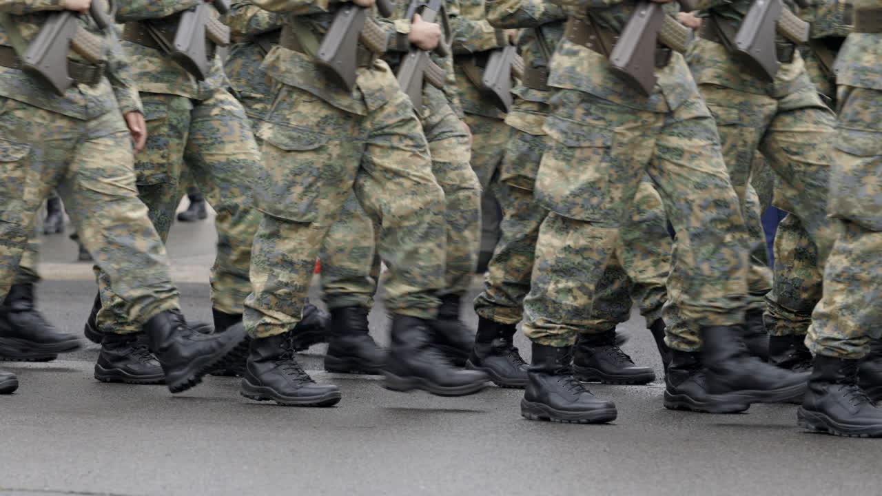 Soldiers marching in camouflage uniforms