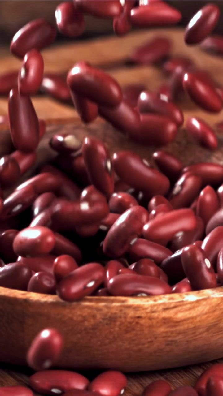 Red Kidney Beans Falling into a Wooden Bowl in Slow Motion