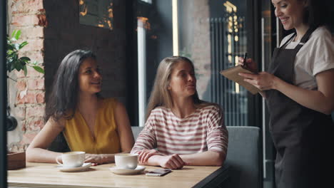 women ordering coffee at a cafe