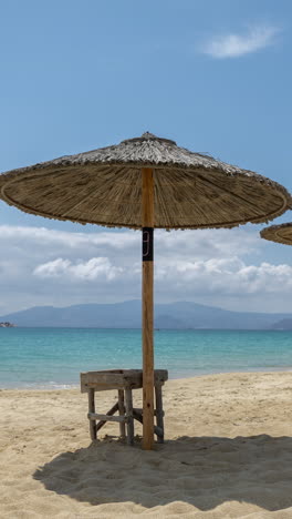 maragkas-beach-in-naxos-island-greece-with-sun-umbrellas-in-vertical