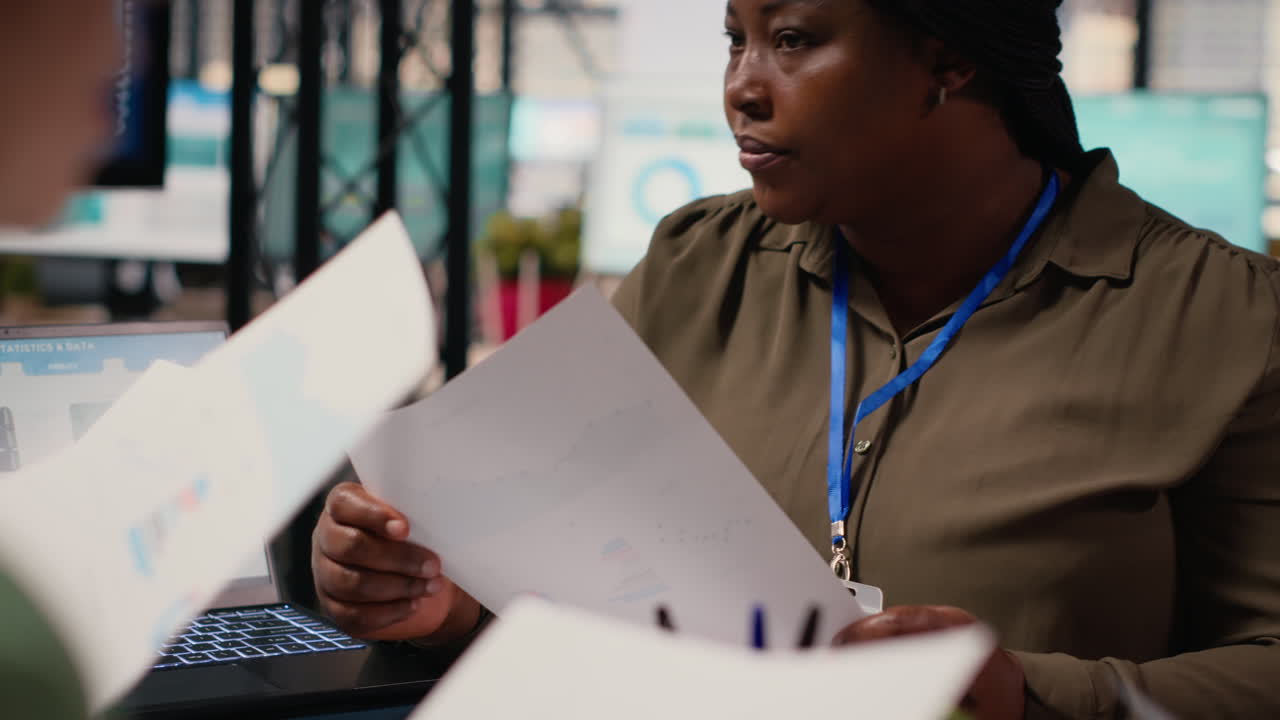 Vertical Video Diverse team of businesswomen gather around the table in a corporate office