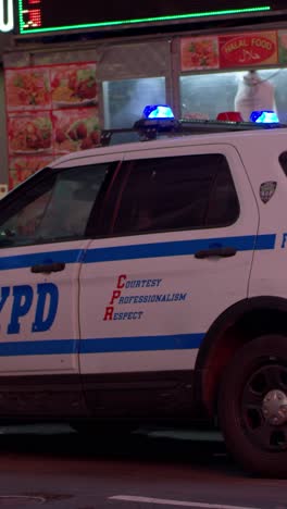 nypd car at food truck at night