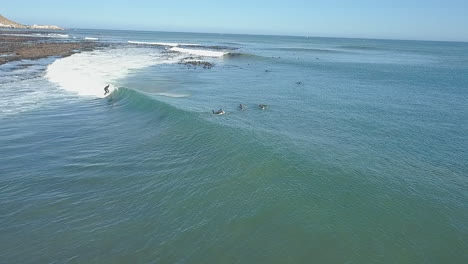 dramatic aerial of surfing along coast in south africa