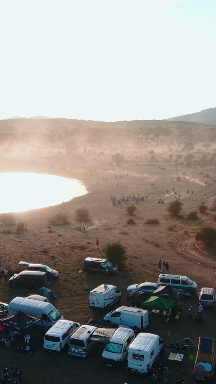 Aerial View of Motocross Event at Sunset Near a Lake