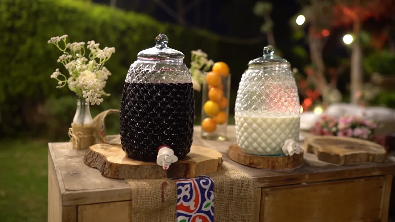 Outdoor drink setup with two glass jars, close up shot