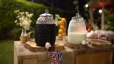 outdoor drink setup with two glass jars, close up shot